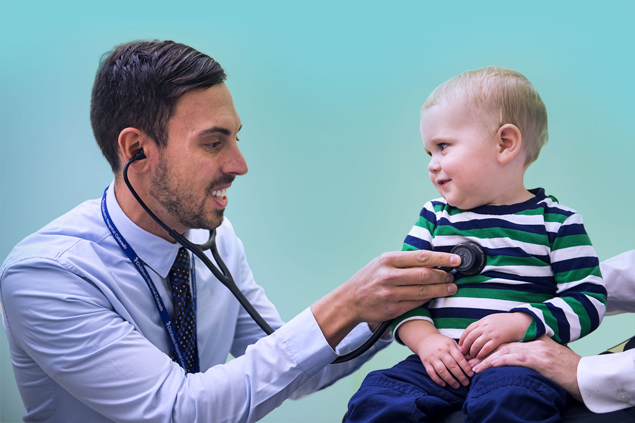 A doctor uses a stethoscope to listen to a baby's heart.